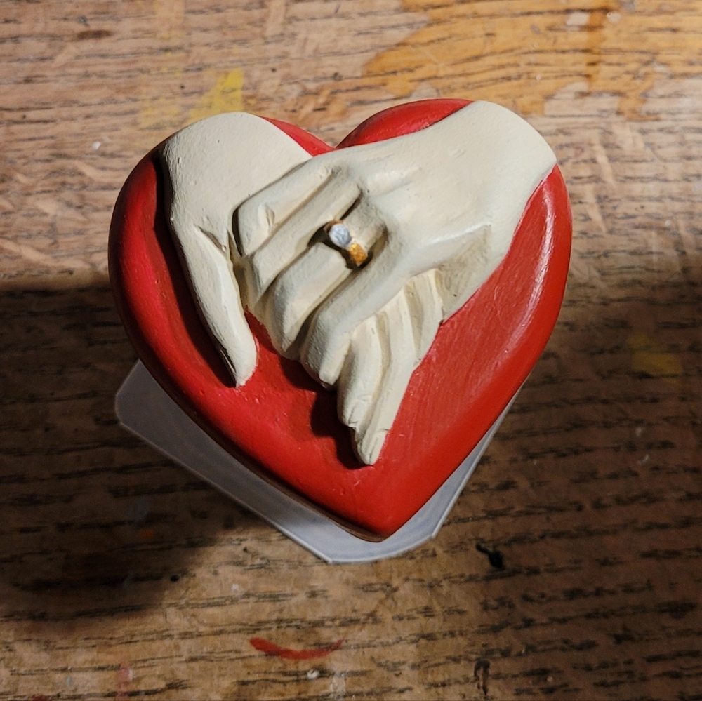 Holding hands with heart (cement)